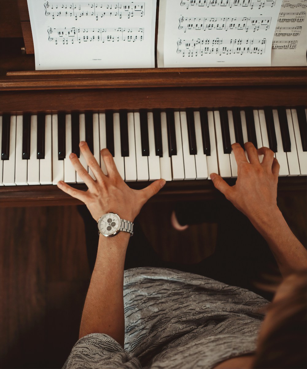 Photo by Vitae London person wearing silver link bracelet round analog watch